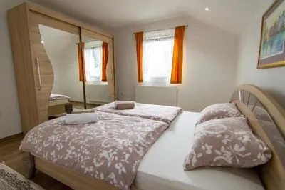 a bedroom with two beds and a mirror at Villa Pliva Lake in Jajce