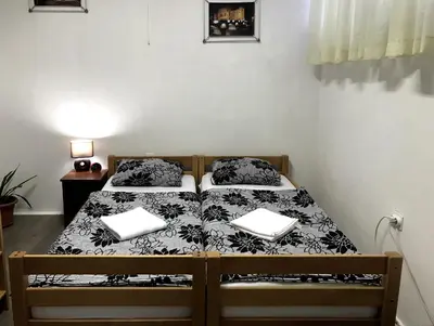 a bedroom with a bed with two laptops on it at Kingdom Rooms Visoko in Visoko