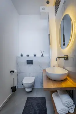 a bathroom with a sink and a toilet and a mirror at Urban city apartment in Visoko