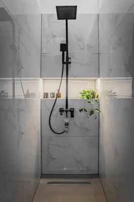 a bathroom with a shower with a shower head at Urban city apartment in Visoko