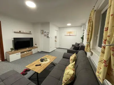 a living room with a couch and a tv at Bijeli Cvijet in Glamočani
