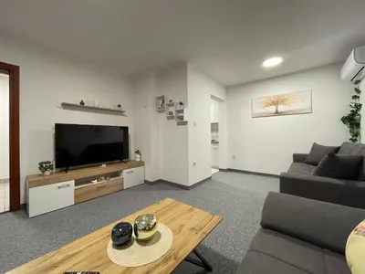 a living room with a couch and a television at Bijeli Cvijet in Glamočani