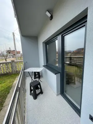 a balcony with a table and a bench on it at Bijeli Cvijet in Glamočani