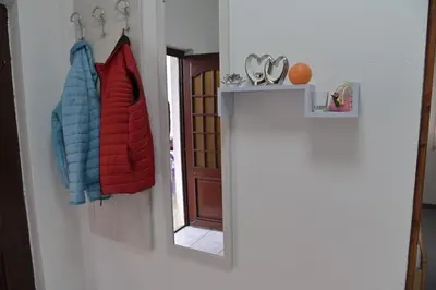 a mirror hanging on a wall next to a door at Bijeli Cvijet in Glamočani