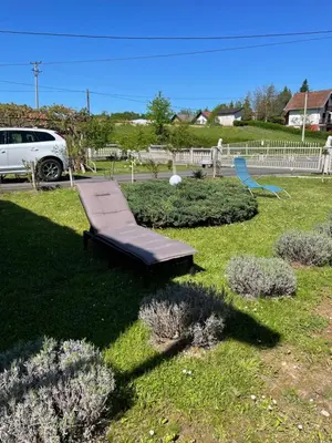 a bench sitting in the grass in a yard at Bijeli Cvijet in Glamočani