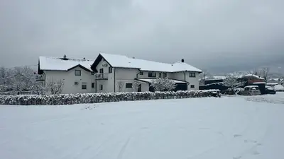 a house is covered in snow in a yard at Milincic‘s 2 Zimmerwohnung in Banja Luka