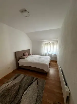 a bedroom with a bed in a white room at Milincic‘s 2 Zimmerwohnung in Banja Luka