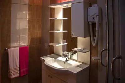 a bathroom with a sink and a shower at Motel Dani in Nova Bila