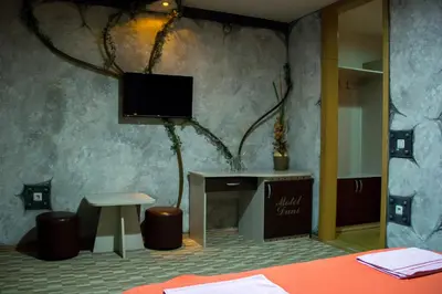 a room with a table and a tv on a wall at Motel Dani in Nova Bila