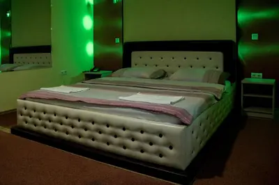 a large bed in a room with green lights at Motel Dani in Nova Bila
