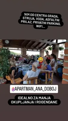 a group of people sitting at tables at a party at Studio Apartman Ana Doboj in Doboj