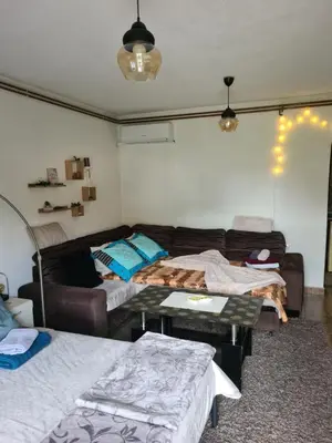 a living room with a couch and a table at Studio Apartman Ana Doboj in Doboj