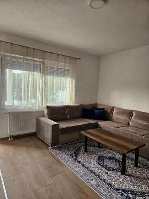 a living room with a couch and a coffee table at Villa Pliva Lake 2 in Jajce
