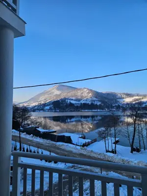 a view of a mountain in the snow from a balcony at Villa Pliva Lake 2 in Jajce