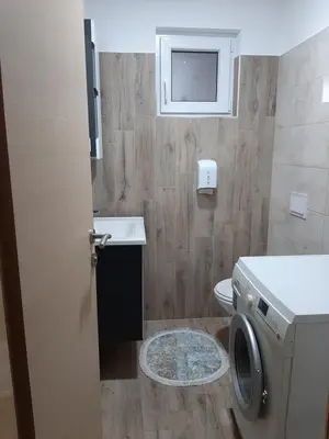 a bathroom with a toilet and a washing machine at Villa Pliva Lake 2 in Jajce