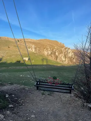 a swing with bikes on it sitting in a field at Obiteljska oaza Vlašić in Vlasic