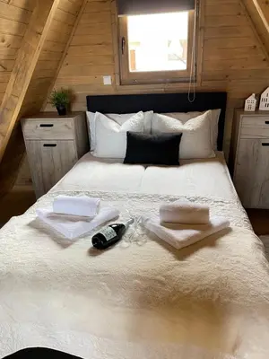 a bedroom with a large bed with towels on it at Obiteljska oaza Vlašić in Vlasic