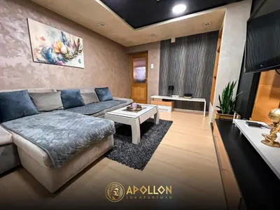 a living room with a couch and a table at Stan na dan Apollon Doboj in Doboj
