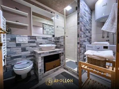 a bathroom with a shower and a toilet and a sink at Stan na dan Apollon Doboj in Doboj