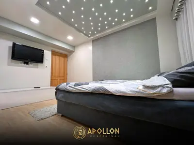 a bedroom with a bed and a flat screen tv at Stan na dan Apollon Doboj in Doboj