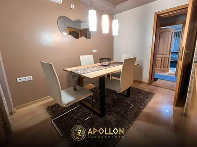 a dining room with a table and white chairs at Stan na dan Apollon Doboj in Doboj