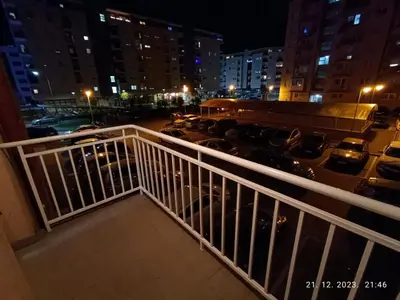 a view of a parking lot from a balcony at night at Ananbi in Banja Luka