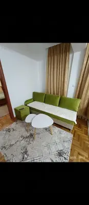a living room with a green couch and a table at Ananbi in Banja Luka