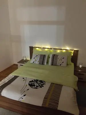 a bedroom with a bed with lights on it at Ananbi in Banja Luka