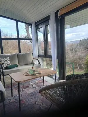a living room with a couch and a table at Apartman Nej&Se Ravne in Visoko