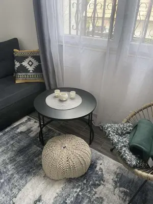 a living room with a table and a couch at Apartman Nej&Se Ravne in Visoko