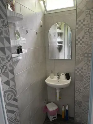 a small bathroom with a sink and a mirror at Apartman Nej&Se Ravne in Visoko