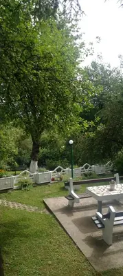 a picnic table and benches in a park at Apartman Nej&Se Ravne in Visoko