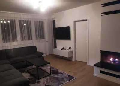 a living room with a couch and a fireplace at Apartman Nona in Kupres
