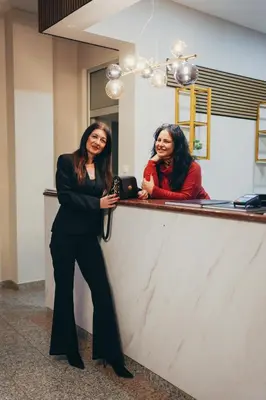 two women standing at a counter in a salon at Wellness Spa Hotel Jola in Banja Luka