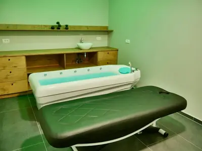 a bath tub in a bathroom with a sink at Wellness Spa Hotel Jola in Banja Luka