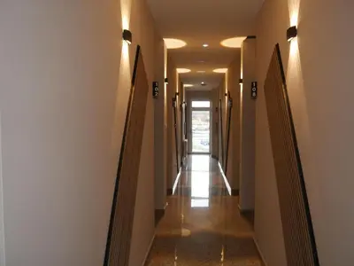 a hallway of a building with lights on the walls at Wellness Spa Hotel Jola in Banja Luka
