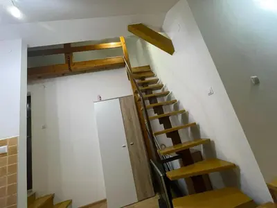 a staircase in a room with a wall with a door at Apartman Centar E&A in Tuzla