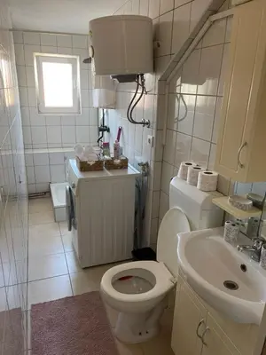a bathroom with a toilet and a sink at Apartman Centar E&A in Tuzla