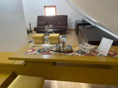a living room with a couch and a table at Apartman Centar E&A in Tuzla