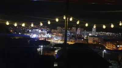 a view of a city at night with lights at Apartment Forever in Tuzla