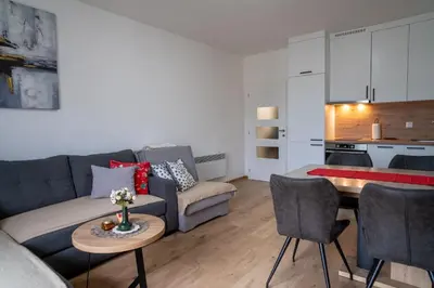 a living room with a couch and a table at Apartment Znaor in Kupres