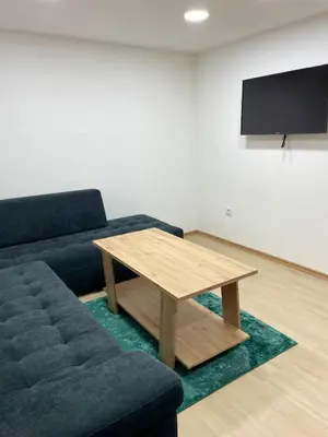 a living room with a couch and a table at Apartman Flora Vlasic in Vlasic