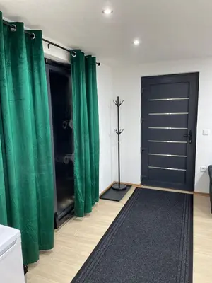 a room with green curtains and a door at Apartman Flora Vlasic in Vlasic