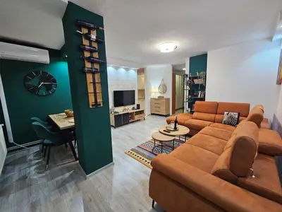 a living room with a couch and a table at Apartman Ema Tuzla in Tuzla