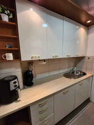 a kitchen with white cabinets and a sink at Apartman Ema Tuzla in Tuzla