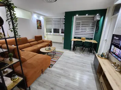 a living room with a couch and a table at Apartman Ema Tuzla in Tuzla