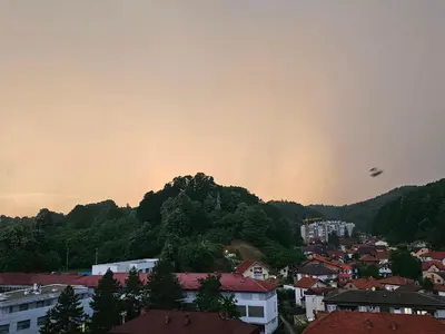 a view of a city with a rainbow in the sky at Apartman Ema Tuzla in Tuzla