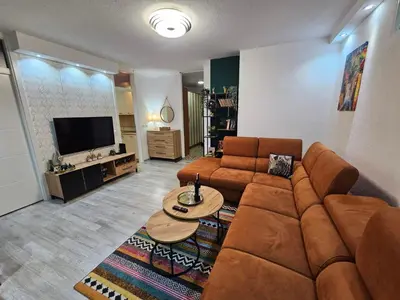 a living room with a couch and a table at Apartman Ema Tuzla in Tuzla