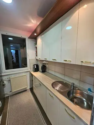 a kitchen with a sink and a large window at Apartman Ema Tuzla in Tuzla