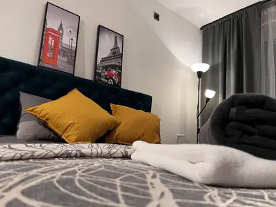 a bedroom with a bed with yellow pillows at Apartman ROYAL Bulevar in Zenica